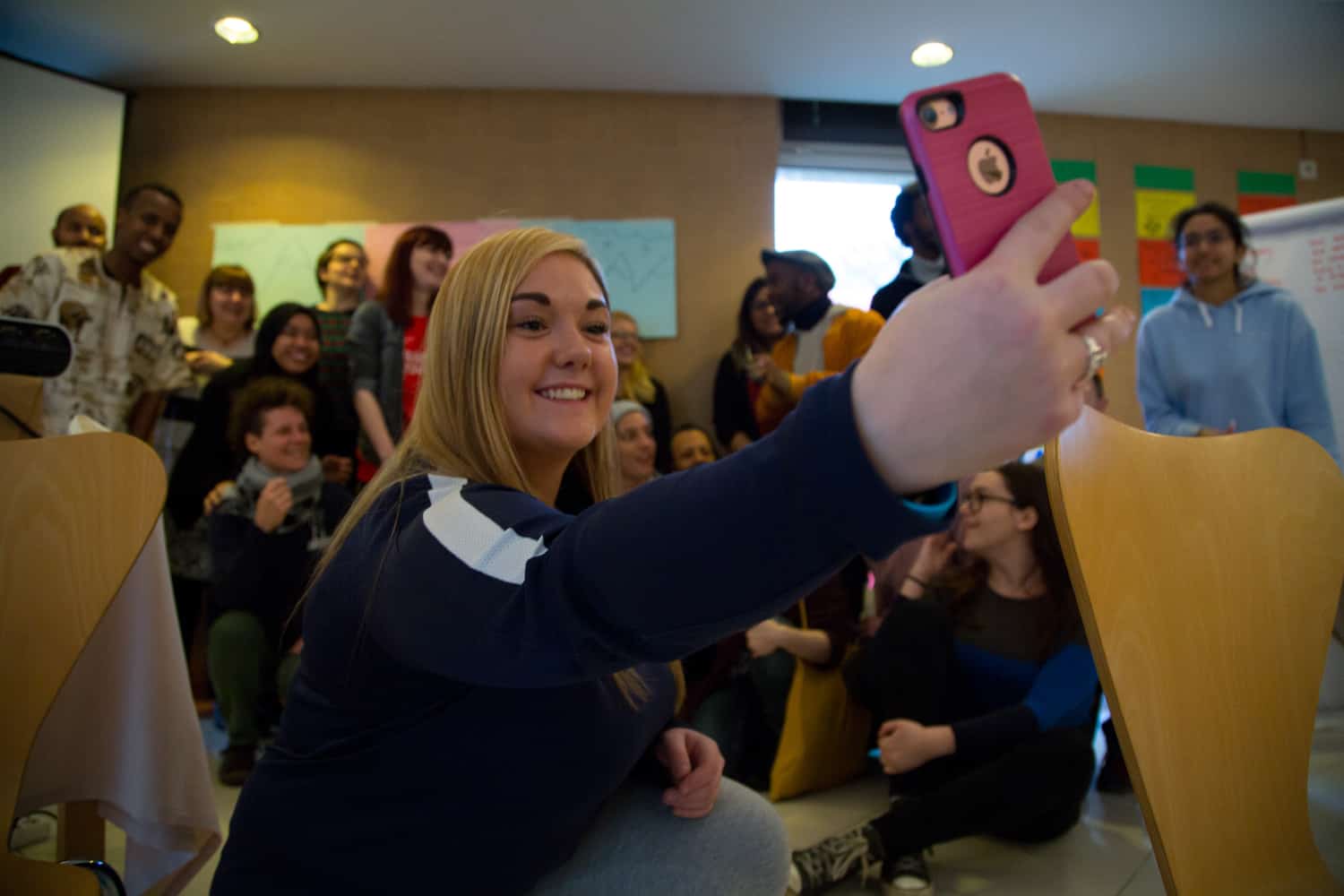 Karen is taking group selfie of trainers of Outside In- project