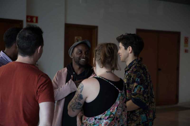 Group of happy trainers. People are standing on group, Everyone is looking each other and smiling.